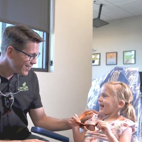 girl with kids dentist in chair girl smiling at kids dentist